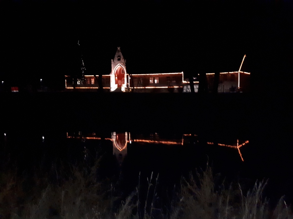 Die Naumburger Weinmanufaktur spiegelt sich im Saalewasser.